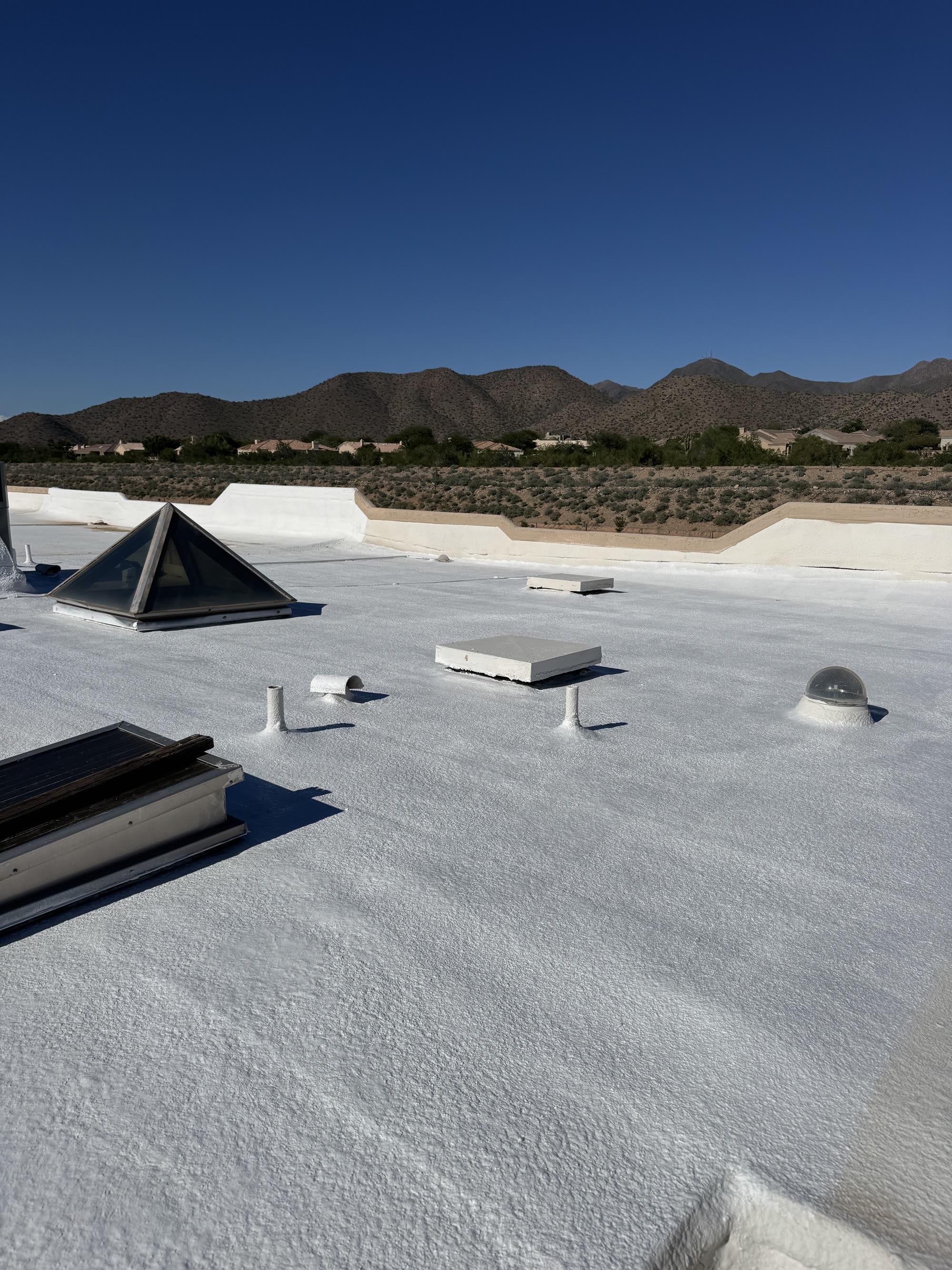 Reflective roof coating in progress